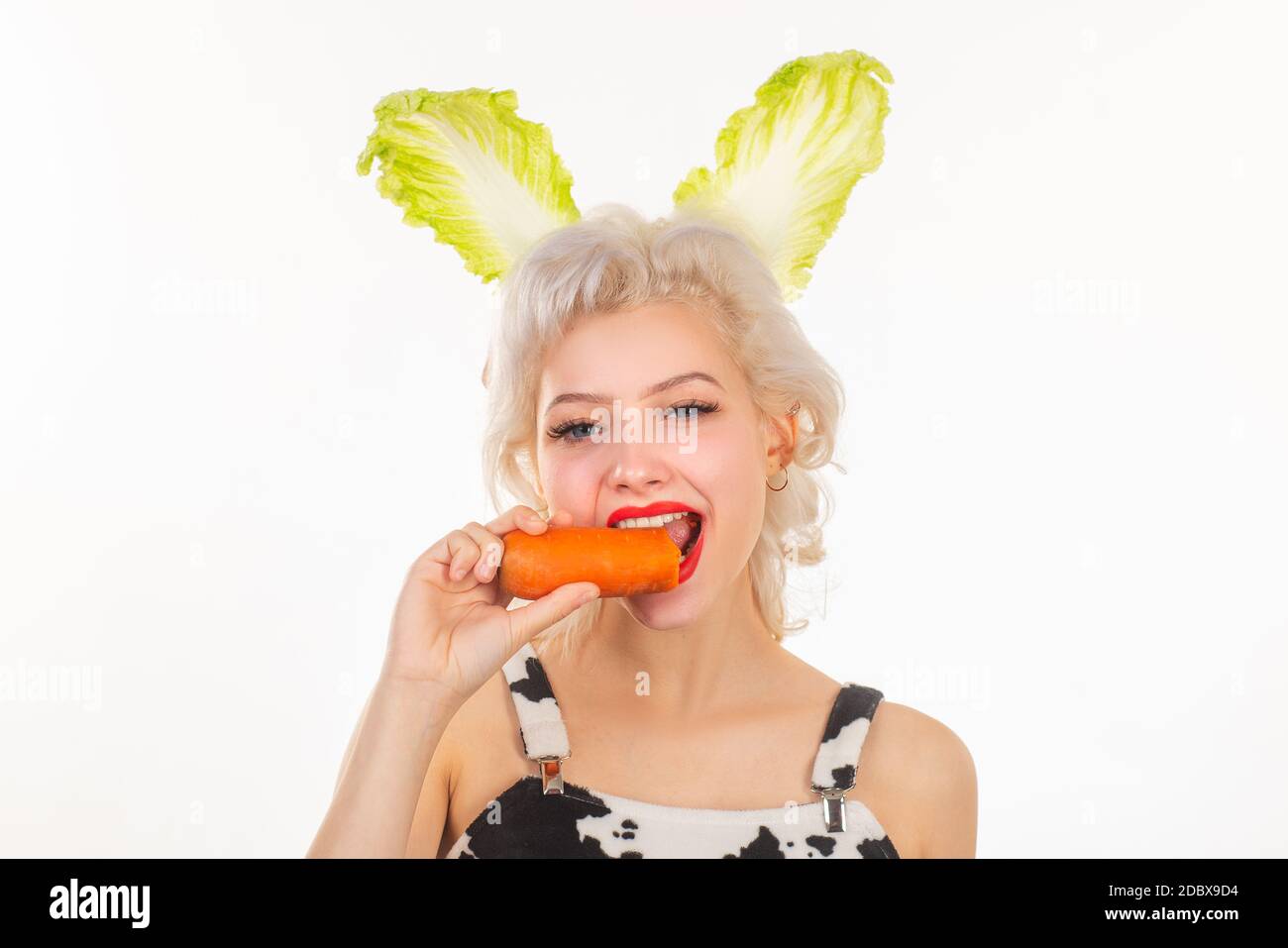 Surprised bunny woman eat carrot. Happy easter and funny easter day ...