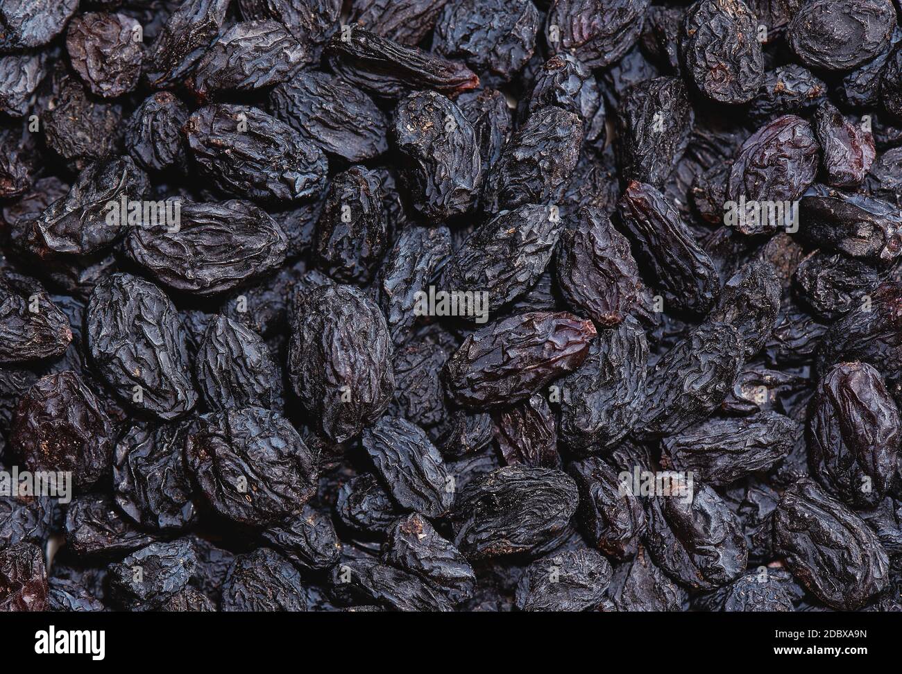 Background, dried black sultana grapes, raisins Stock Photo Alamy