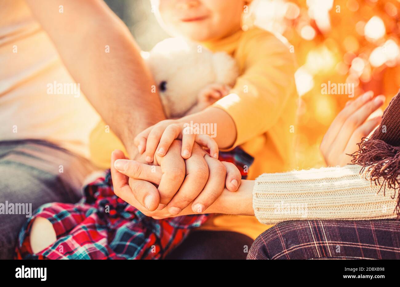 Hands of father, mother, keep hand little baby. Parents hold the baby hands. Closeup of baby hand into parents hands Stock Photo