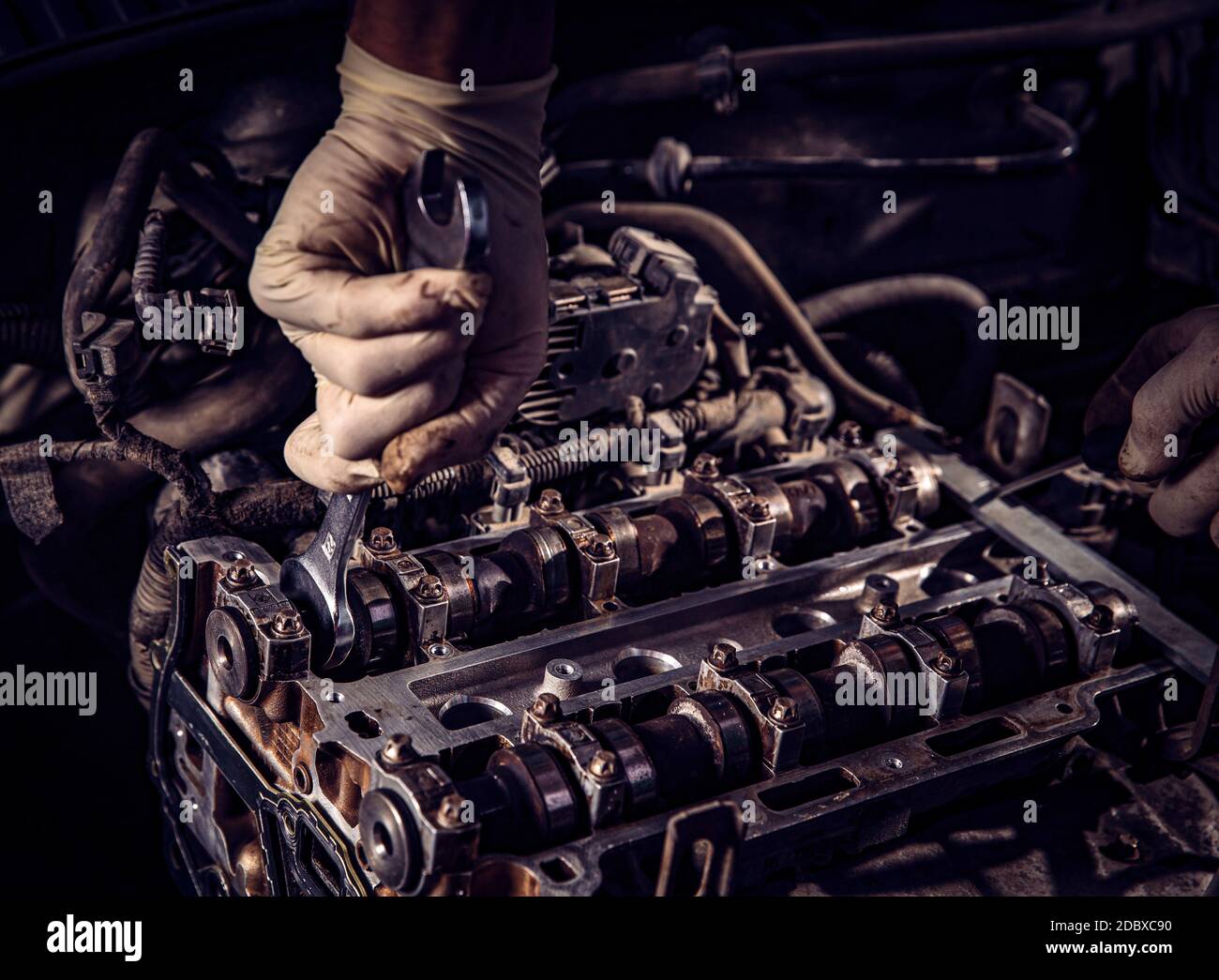 Car mechanic working in auto repair service and maintenance engine