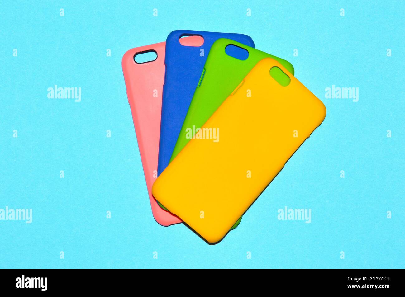 Colorful phone cases isolated on blue background Stock Photo