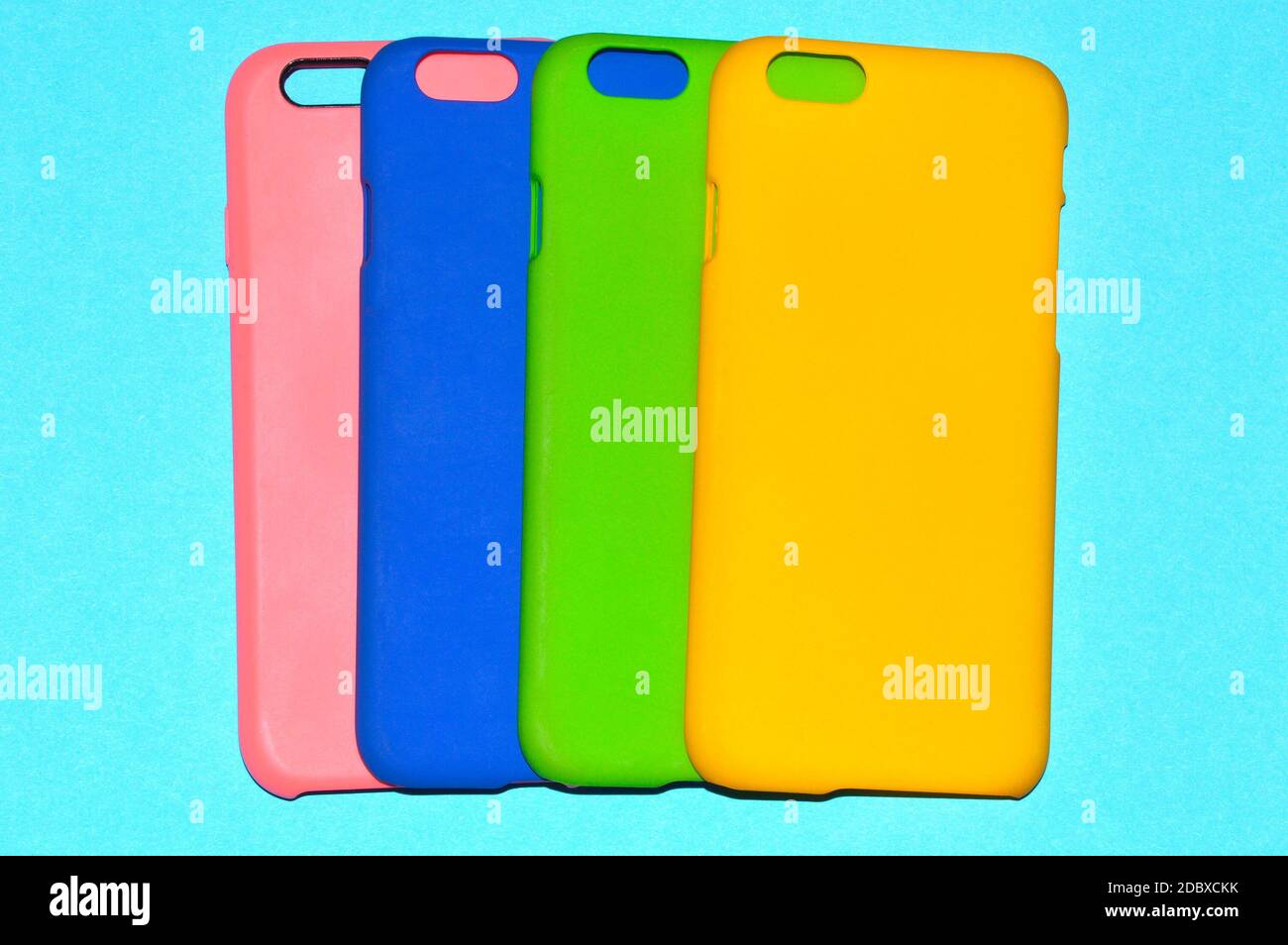 Colorful phone cases isolated on blue background Stock Photo