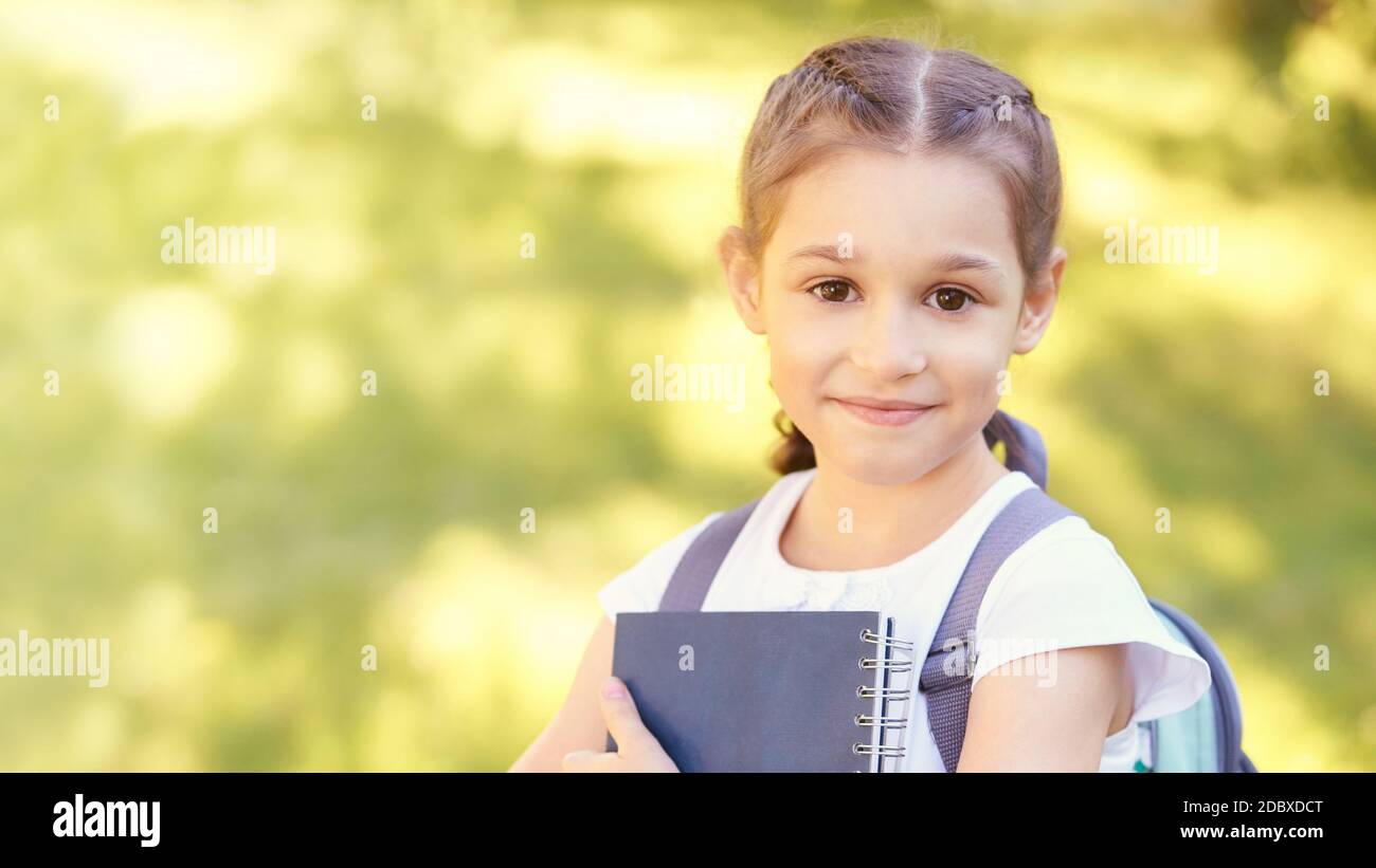 Young pretty girl holding books. School concept Stock Photo - Alamy