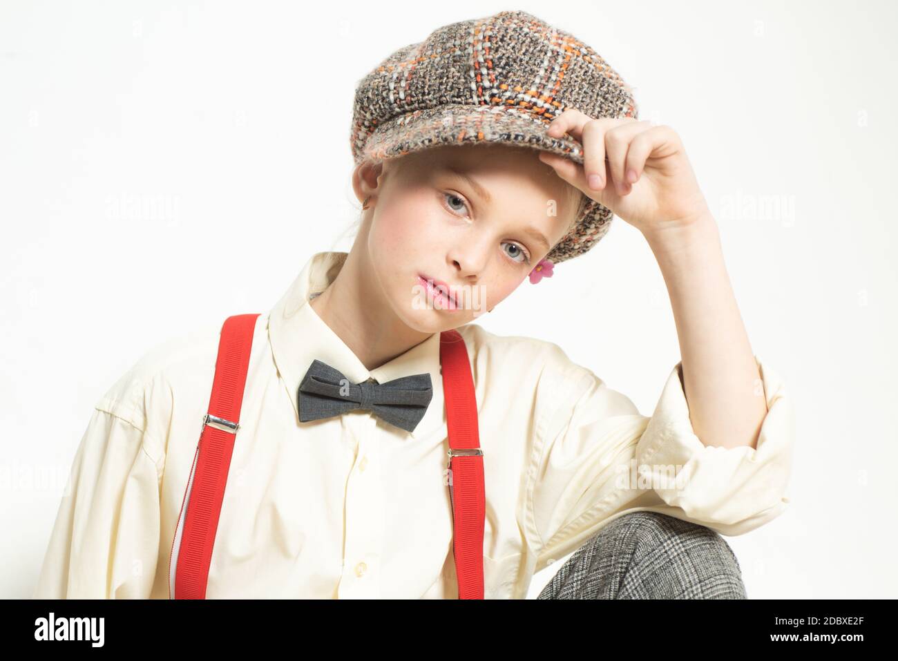 Confident in her style. teen girl in retro suit. suspender and bow tie. old fashioned child in checkered beret. vintage english style. jazz step Stock Photo