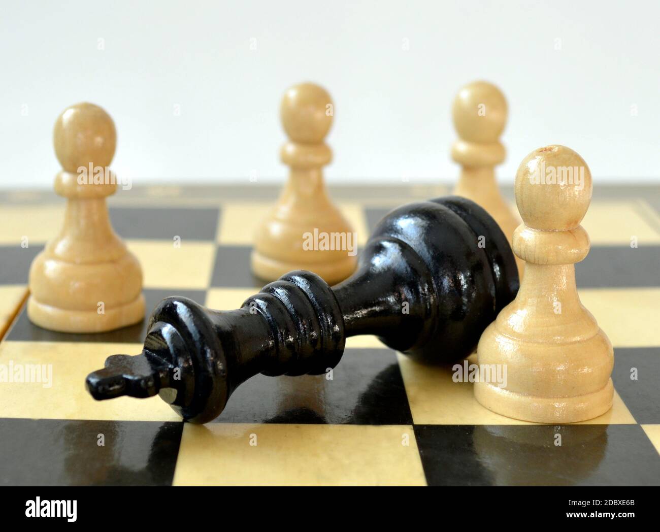 The white pawn defeated black king on chess board Stock Photo