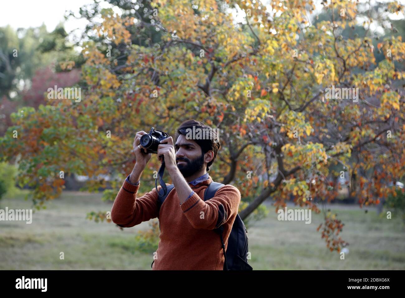 Islamabad, Pakistan. 17th Nov, 2020. A man takes photos at Fatima Jinnah Park in Islamabad, capital of Pakistan, Nov. 17, 2020. Credit: Ahmad Kamal/Xinhua/Alamy Live News Stock Photo