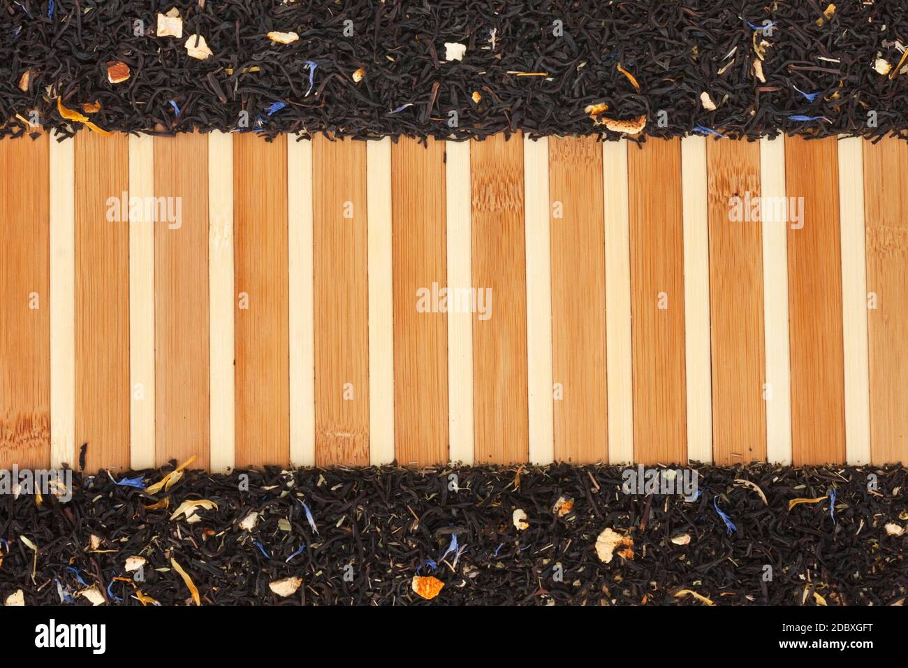 Dried  black  tea  on a bamboo mat, with space for text Stock Photo