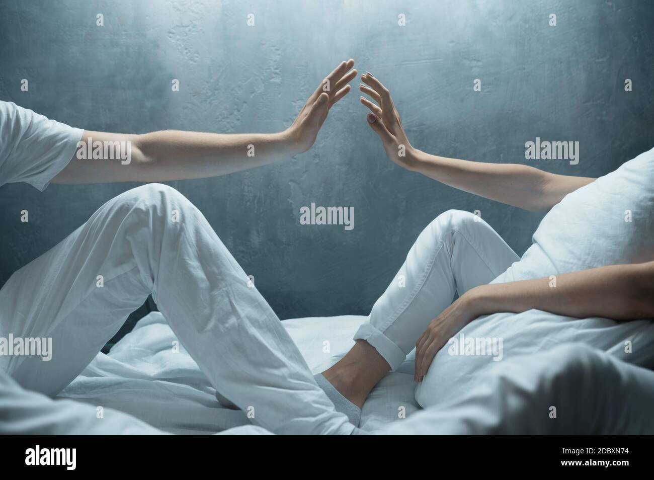 Crazy man and woman are sitting in bed, insomnia, dark room on background. Psychedelics having problems every night, depression and stress, sadness, p Stock Photo