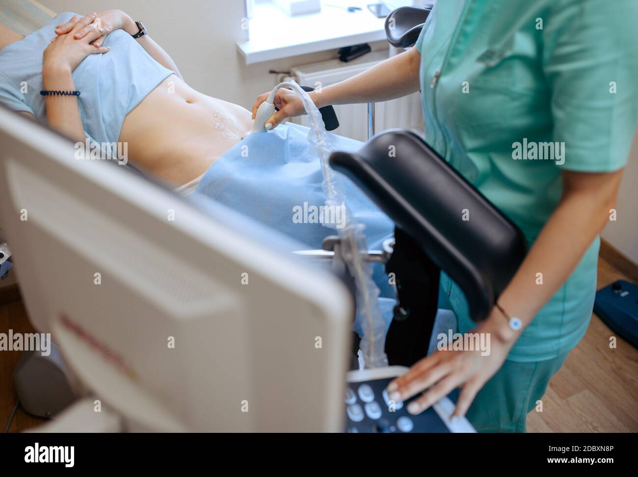 Female gynecologist makes ultrasound scan. Gynecological examination in