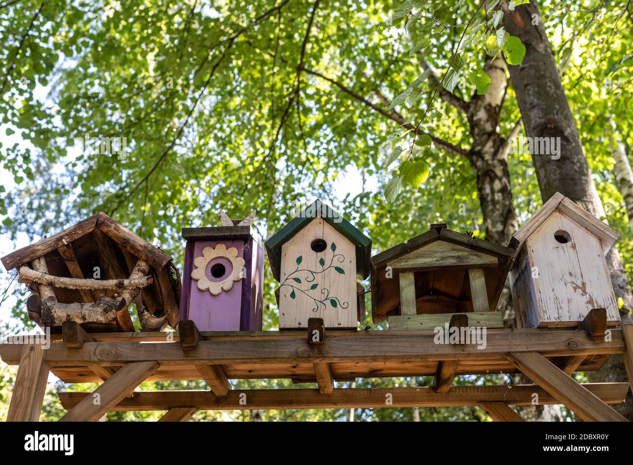 Old decorative bird feeders and wooden birdhouses Stock Photo - Alamy