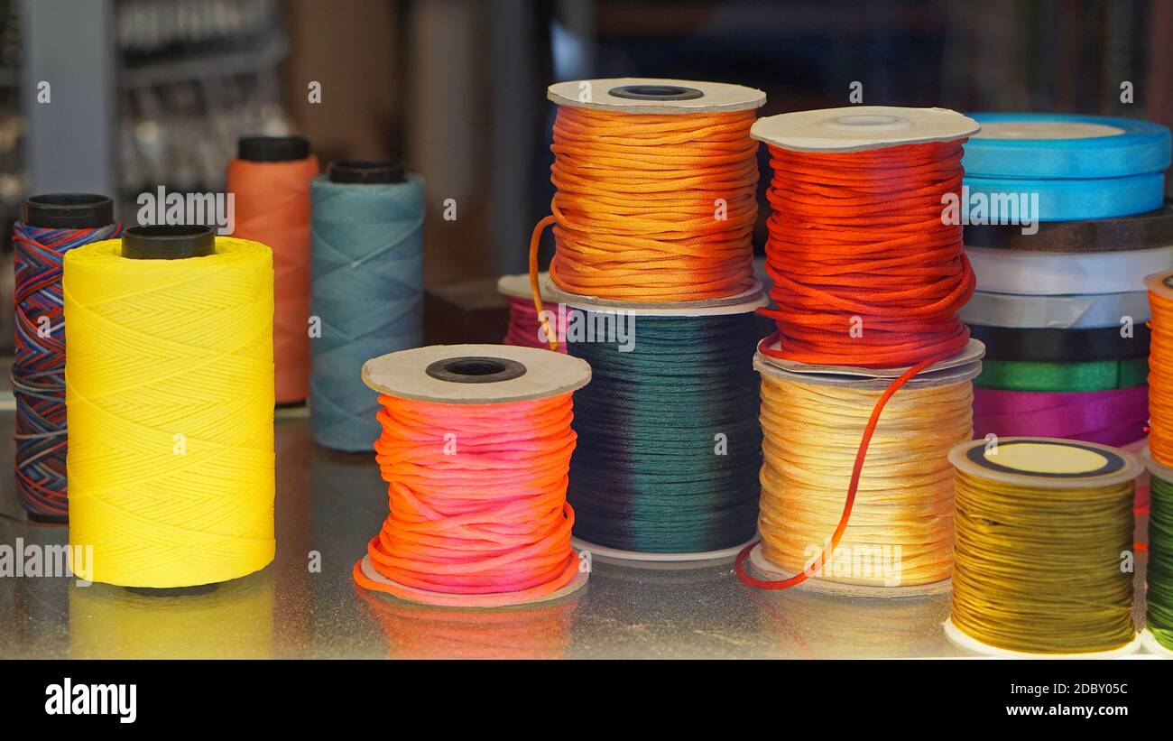Colorful sewing threads and yarns at bobbins Stock Photo - Alamy