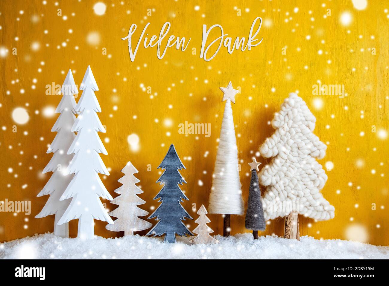 Christmas Trees With German Calligraphy Vielen Dank Means Thank You. Yellow Wooden Rustic Background With Snow And Snowflakes. Christmas Decoration Wi Stock Photo
