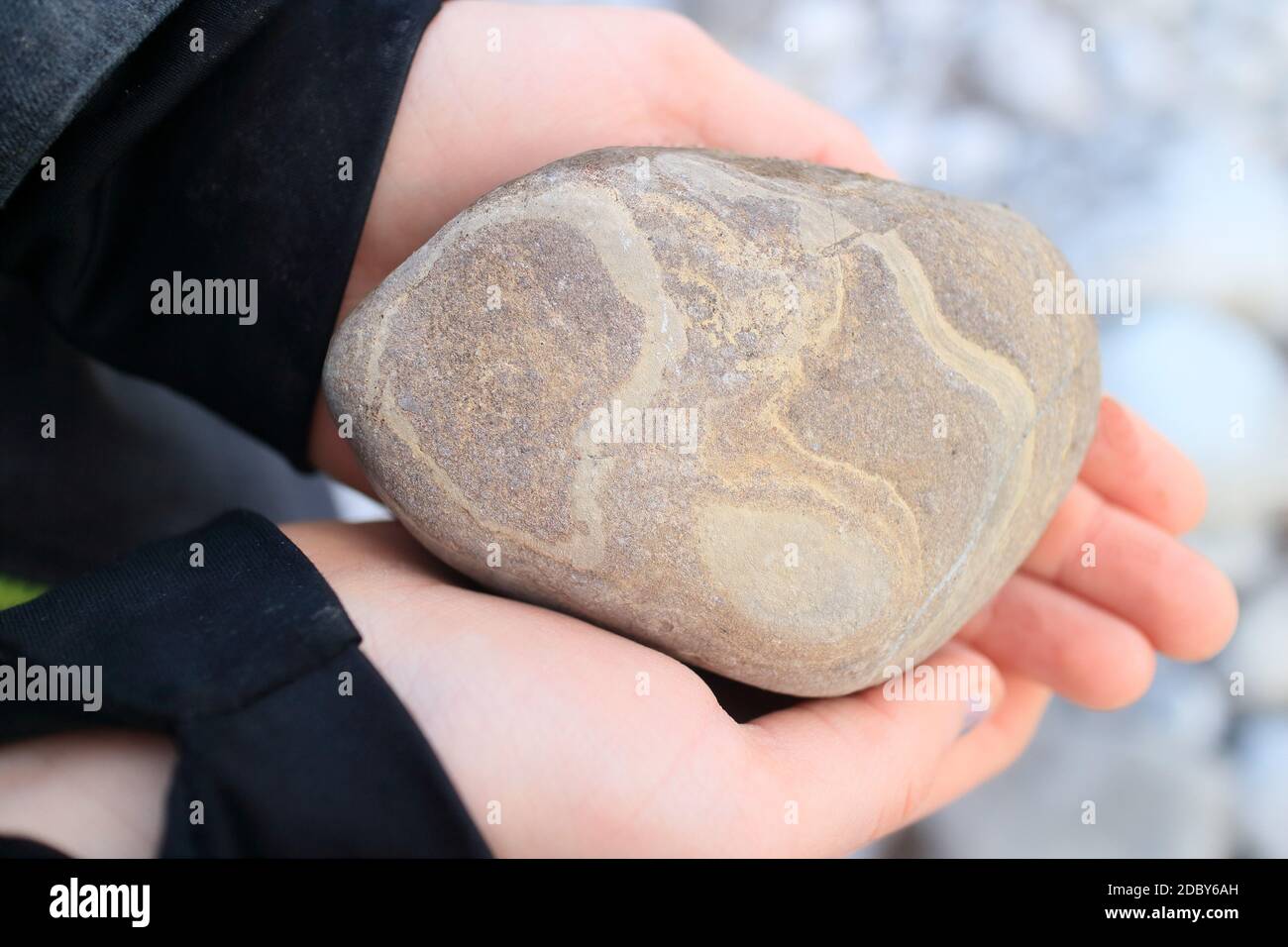 colored stone in hand of a child Stock Photo