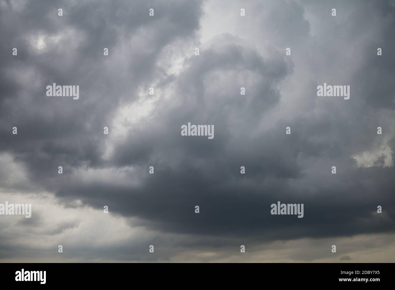 The gray sky is covered with heavy, leaden clouds. Stock Photo