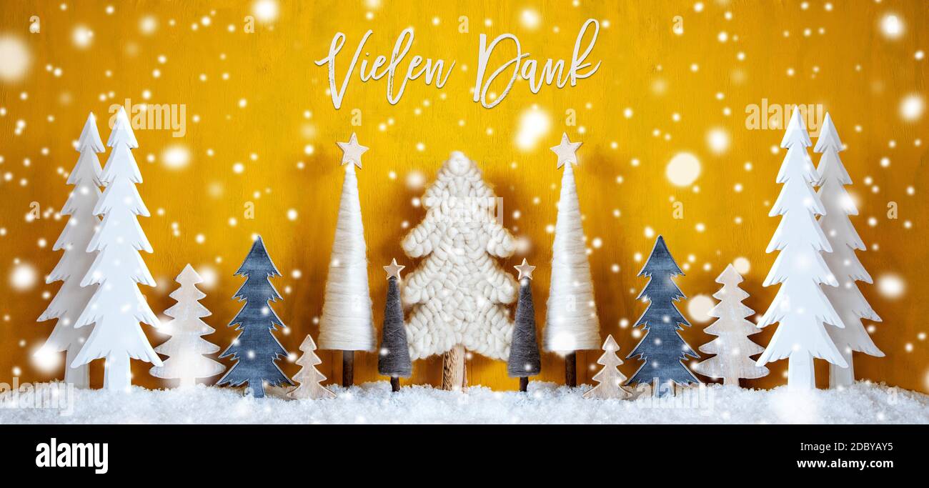 Banner Of Christmas Trees With German Calligraphy Vielen Dank Means Thank You. Yellow Wooden Rustic Background With Snow And Snowflakes. Christmas Dec Stock Photo