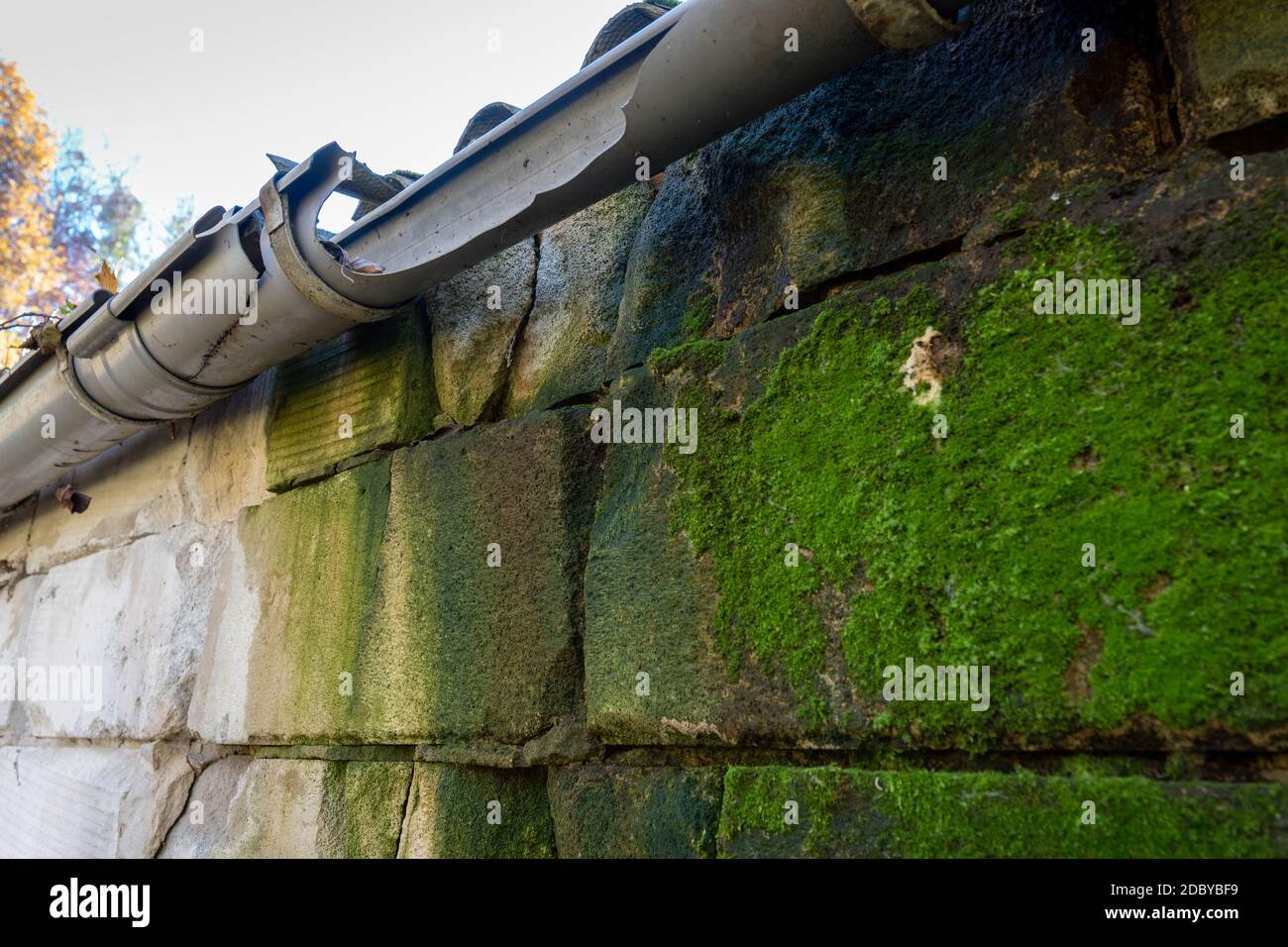 broken gutter on the roof of a house Stock Photo