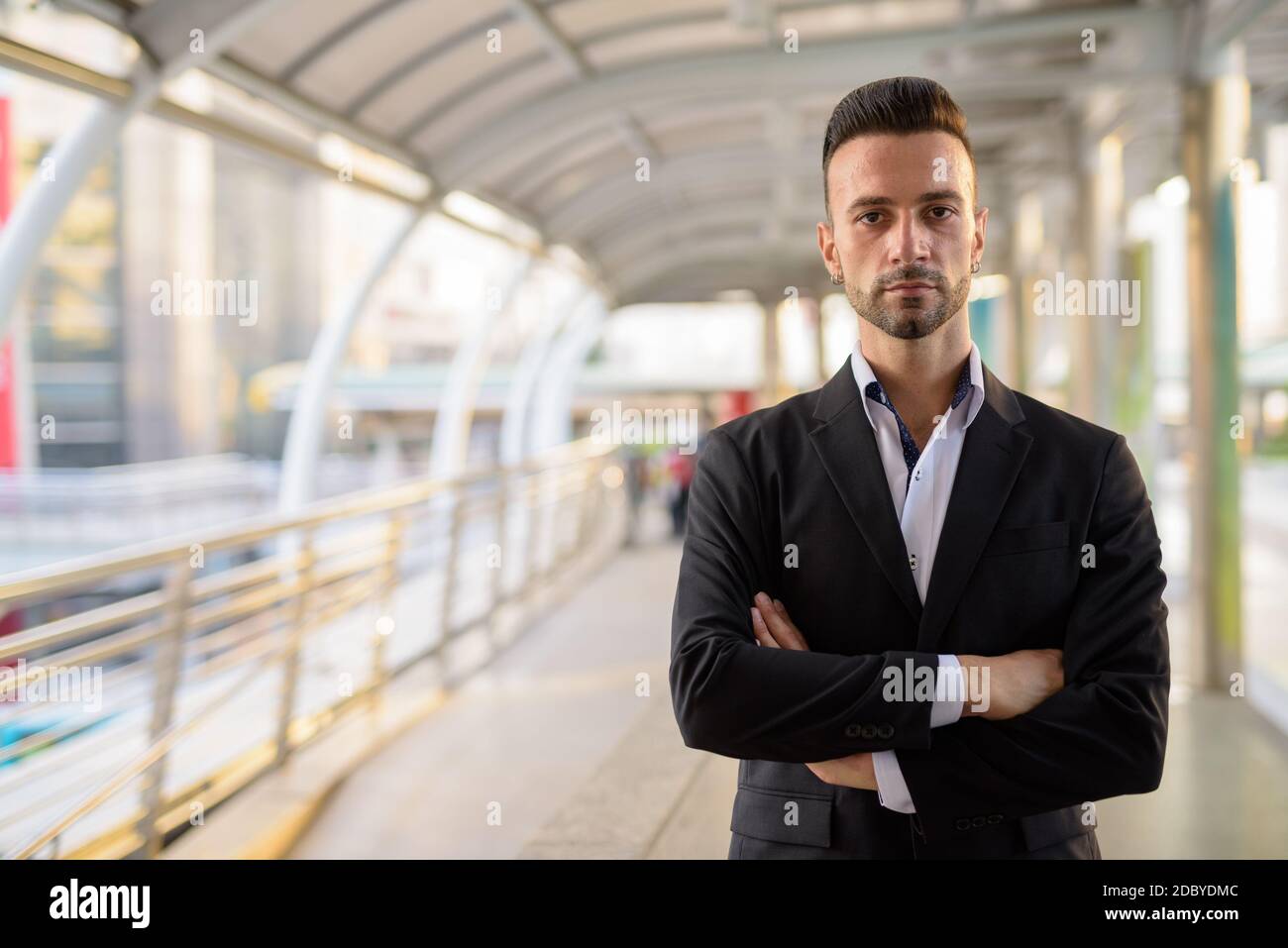 Confident businessman outdoors in city with arms crossed Stock Photo ...