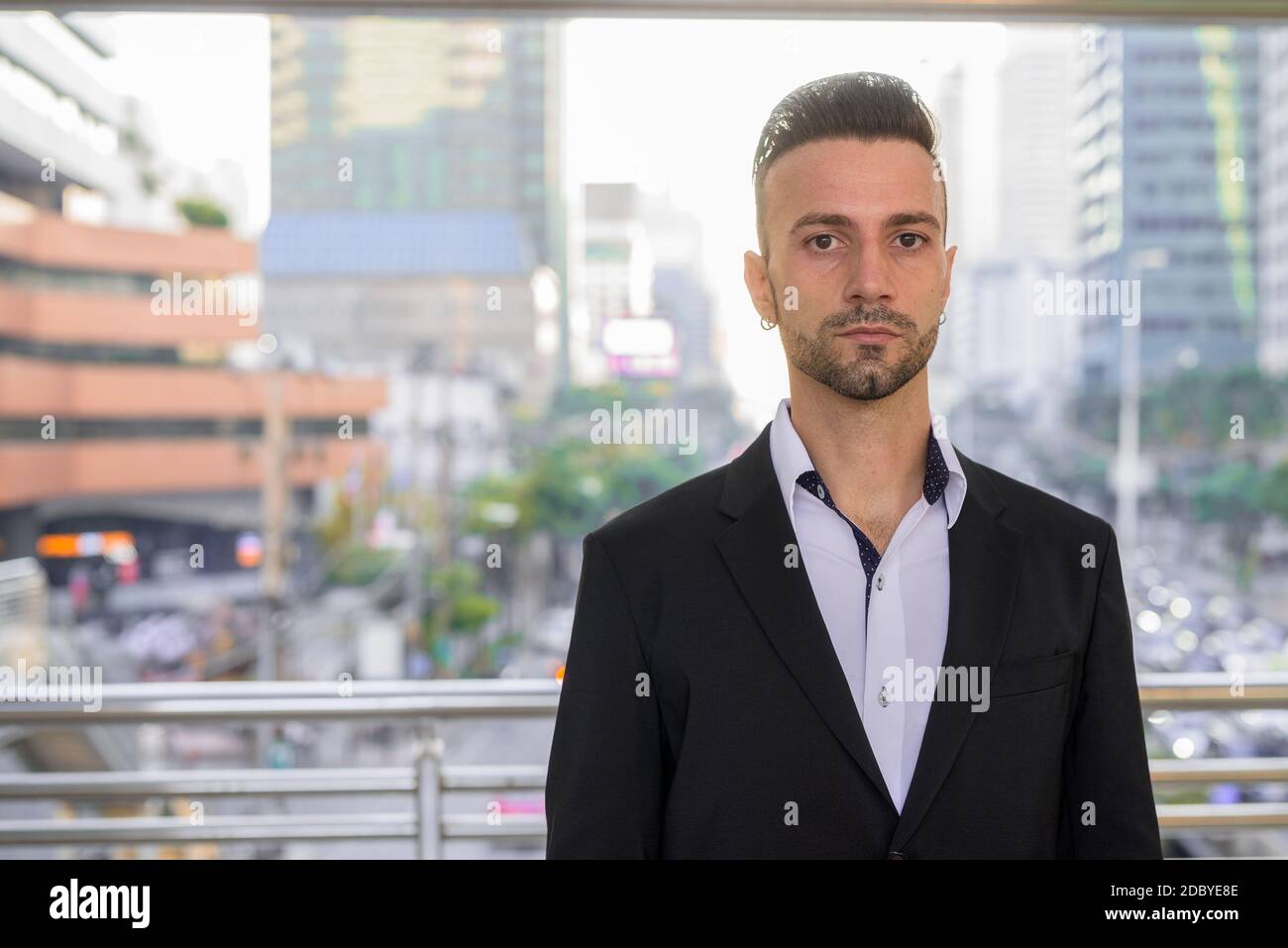 Portrait of handsome young businessman outdoors in city Stock Photo - Alamy