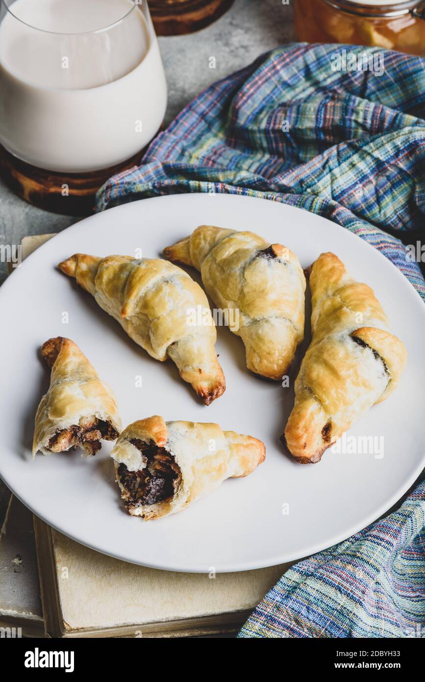 Fresh baked croissants stuffed with nuts and chocolate spread for breakfast Stock Photo