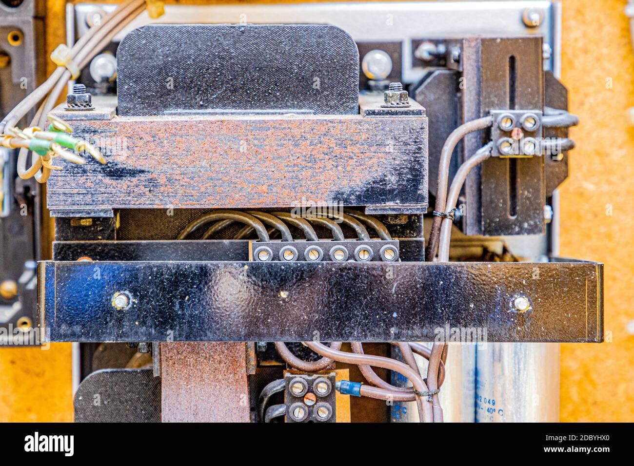 Dirty and rusty metal structure with dirty electrical wires cut into a ...