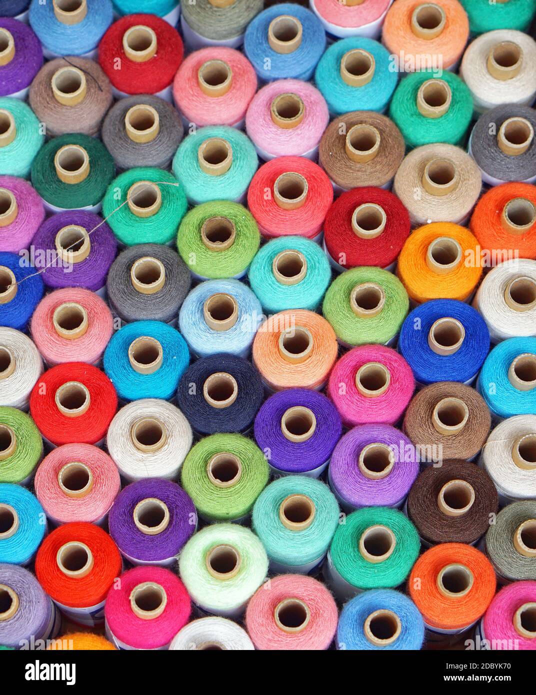 Colorful sewing threads and yarns at bobbins Stock Photo - Alamy