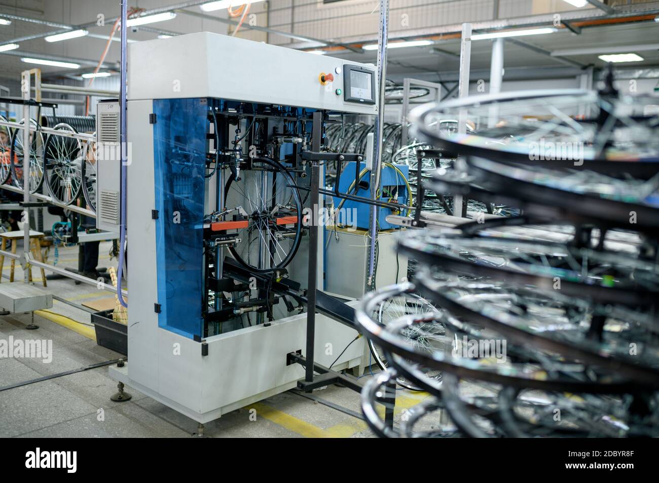 New aluminum bicycle wheels on professional assembly line, spokes installation, nobody. Bike