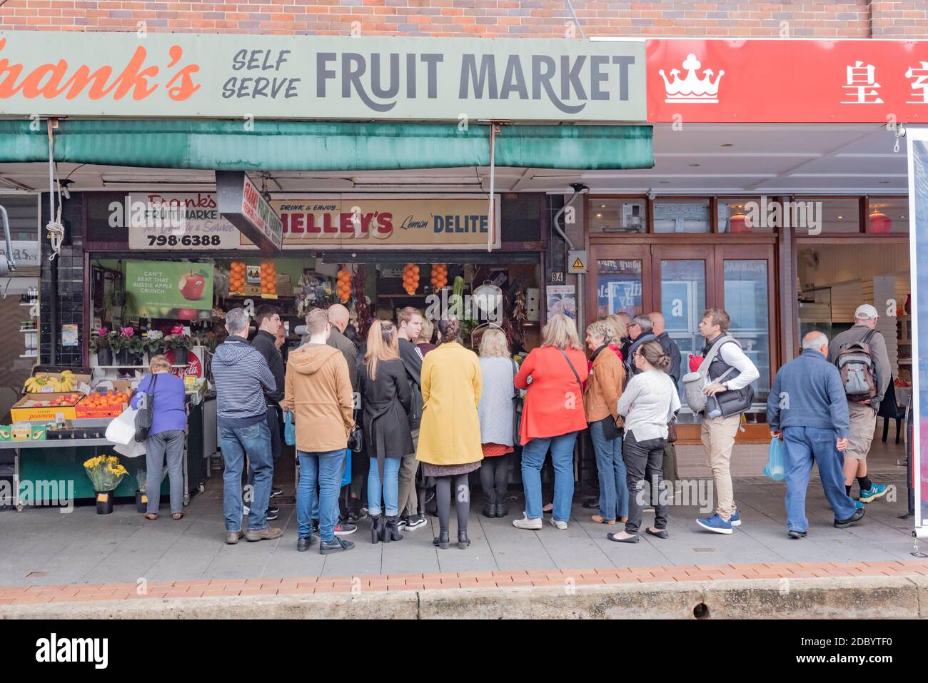 A crowd of people on a local food safari (walk) outside the famous Haberfield grocer Franks Fruit Market. Frank Bonfante has been here since 1974 Stock Photo