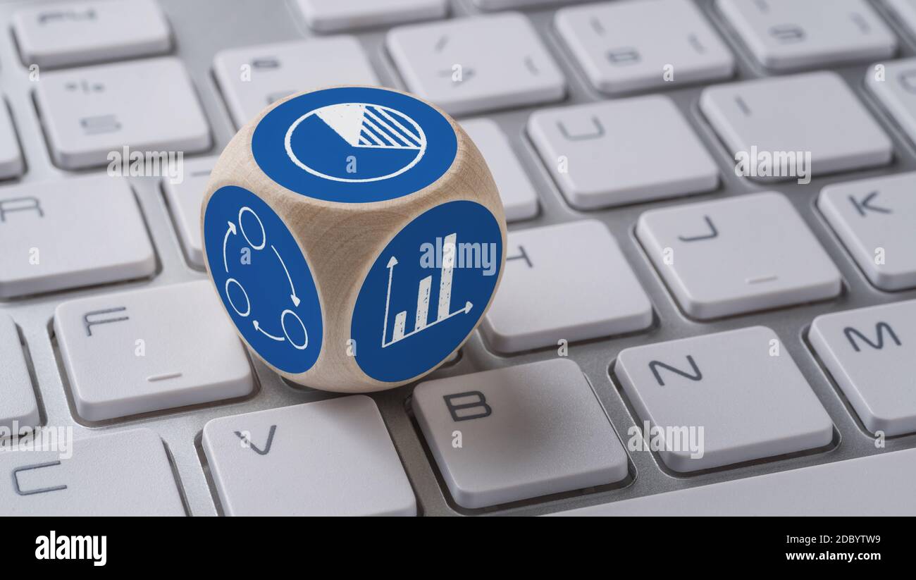 A die with icons on a keyboard - Statistics Stock Photo - Alamy
