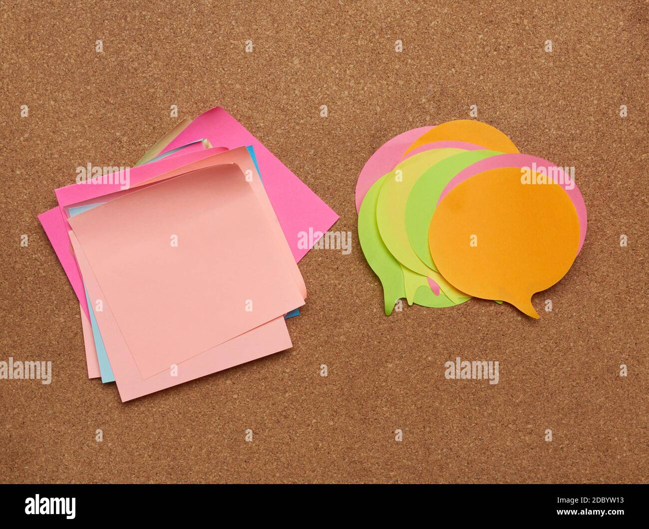 colorful paper stickers glued on brown balsa board, idea and multitasking, close up Stock Photo