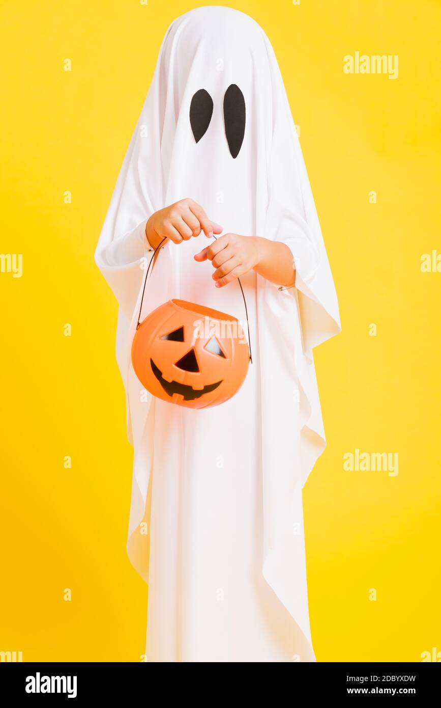 Funny Halloween Kid Concept, little cute child with white dressed