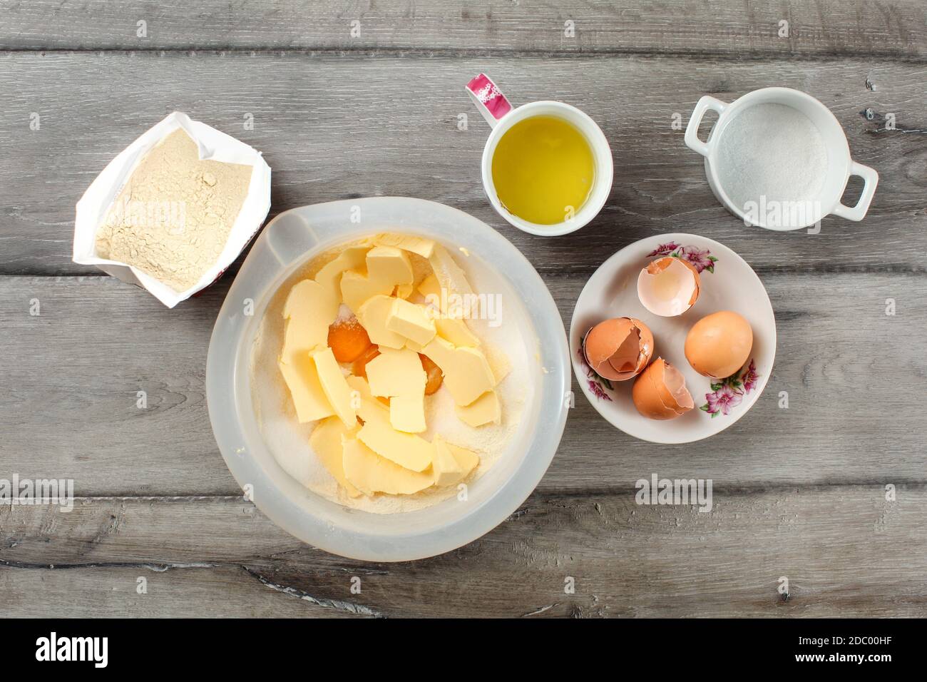 Table top view on ingredients for cake preparation. Sack of flour, bowl