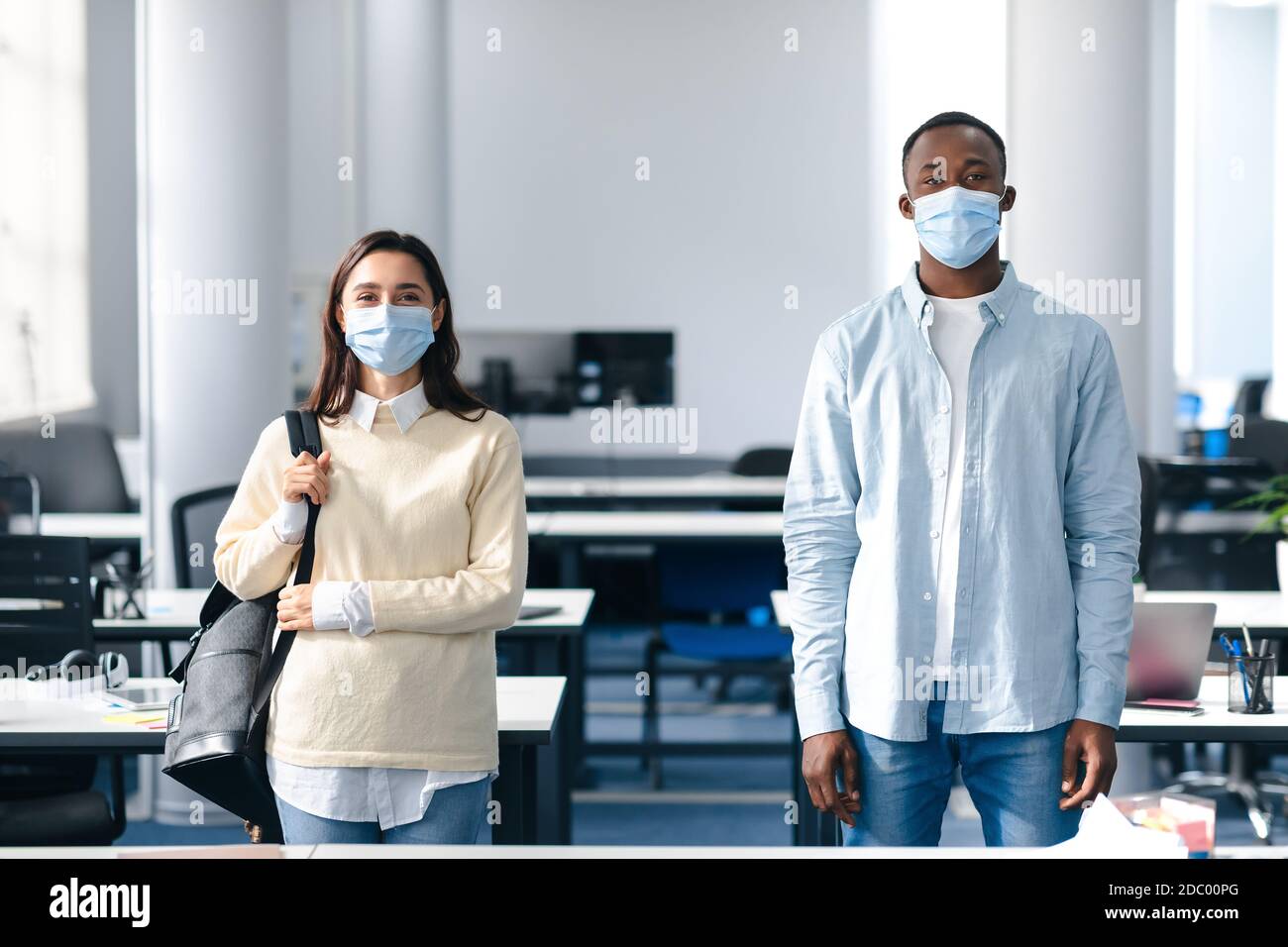 Portrait of international students wearing protective medical masks Stock Photo