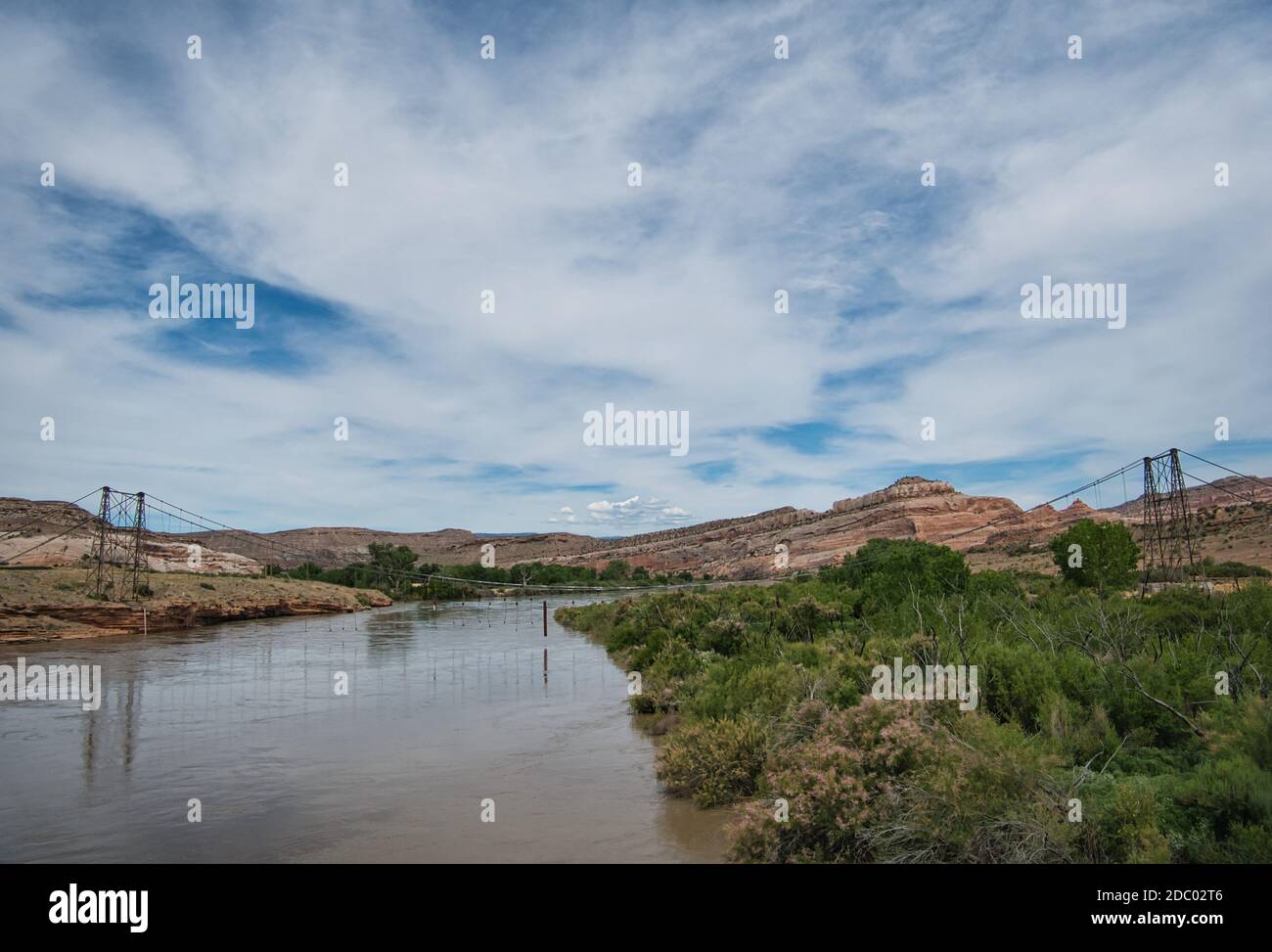 An old collapsed suspension bridge over the Colorado River Stock Photo