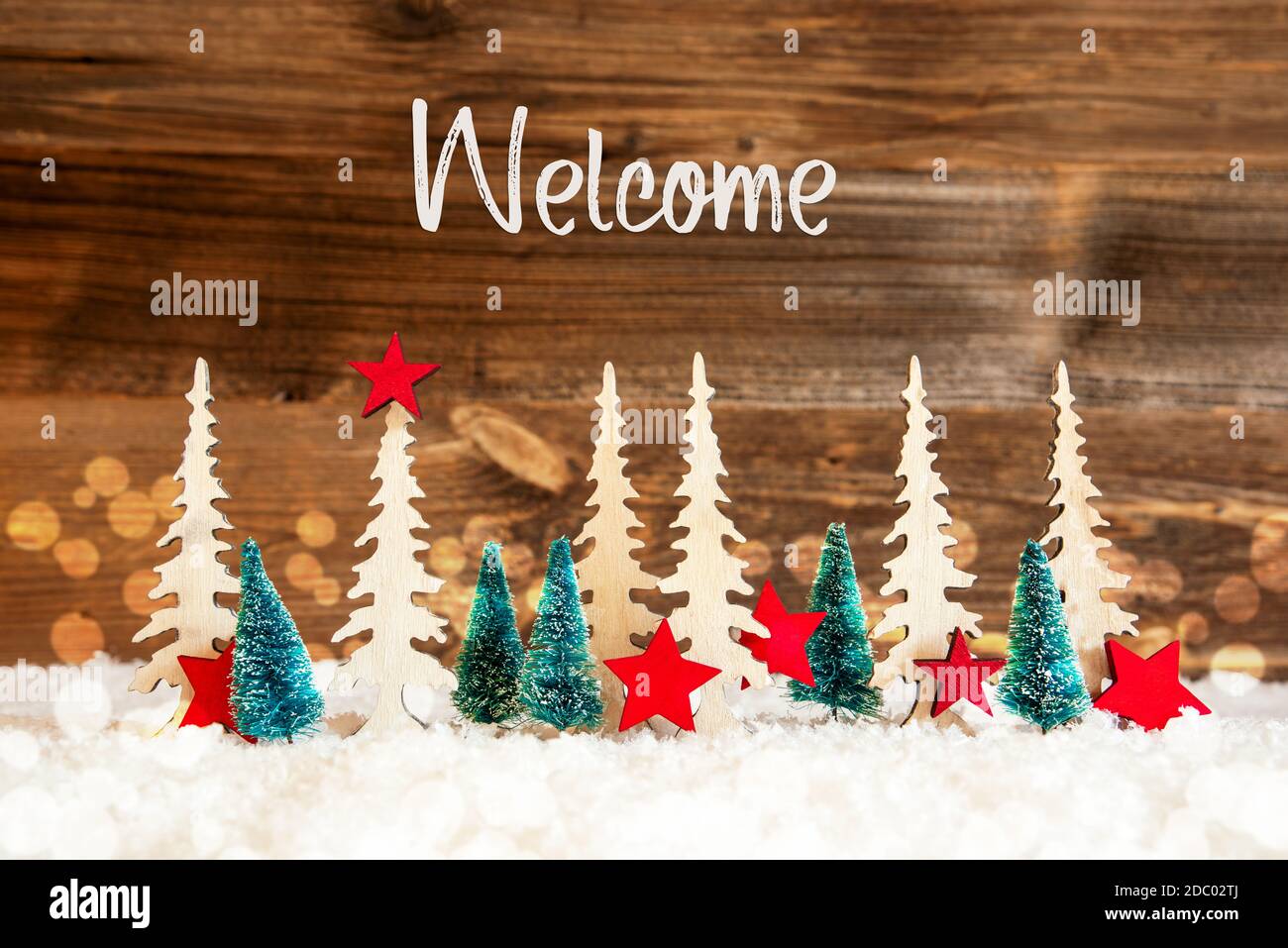 Christmas Trees With English Text Welcome. Christmas Decoration Like Red  Star Ornament. Rustic Brown Wooden Background With Snow And Bokeh Effect  Stock Photo - Alamy