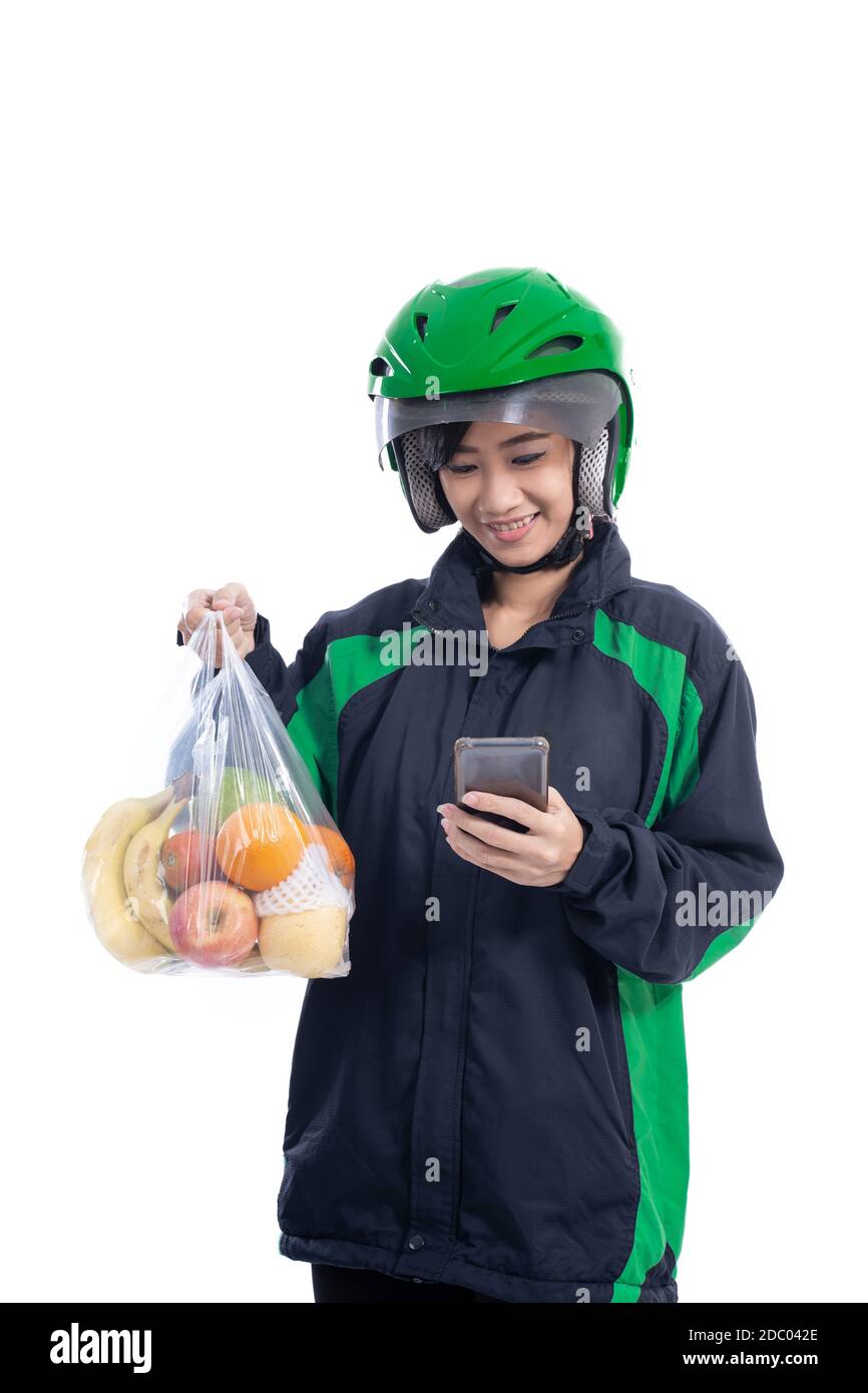 female uber delivery courier wearing helmet bring groceries in plastic bag isolated over white