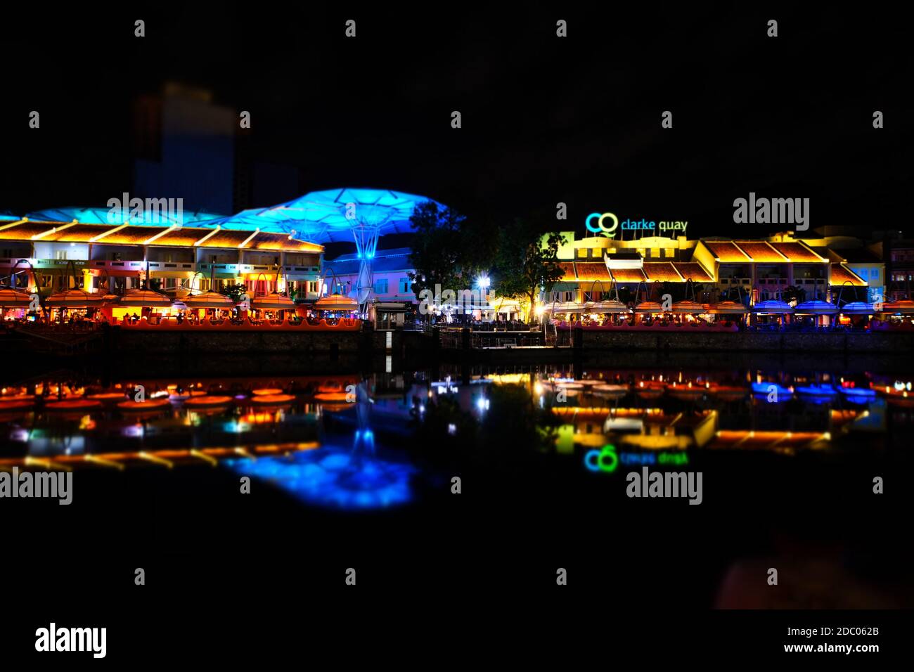 Clarke Quay is extremely colourful and full of life at night. It is one of Singapore's busy dining and entertainment hubs along the Singapore river. Stock Photo
