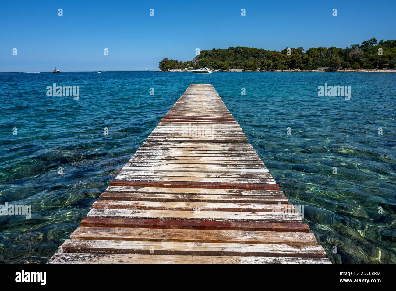 Old and worn jetty with turquoise waters seen near Rovinj, Croatia Stock Photo