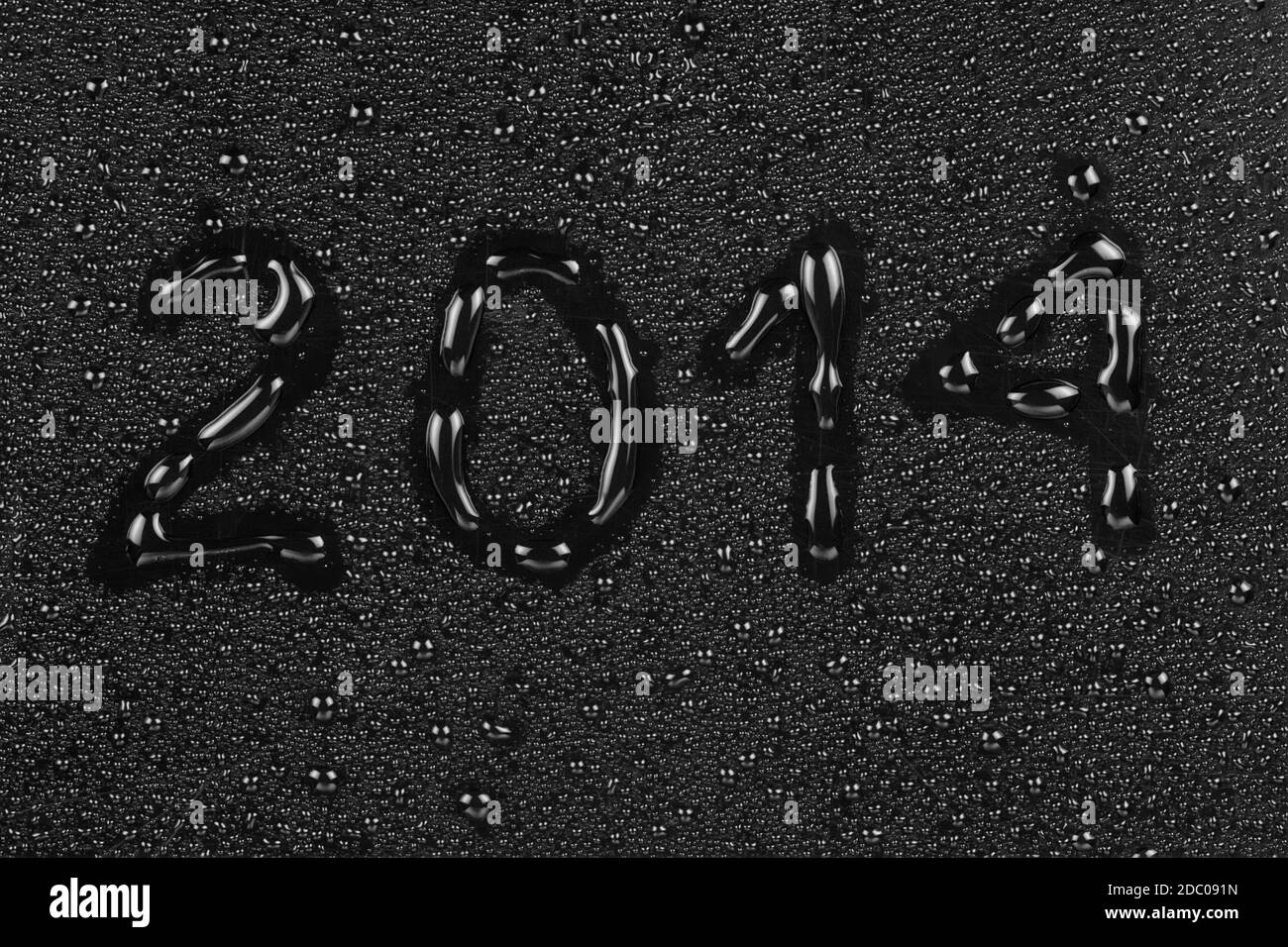 Inscription from 2014 written on a black background with water Stock ...