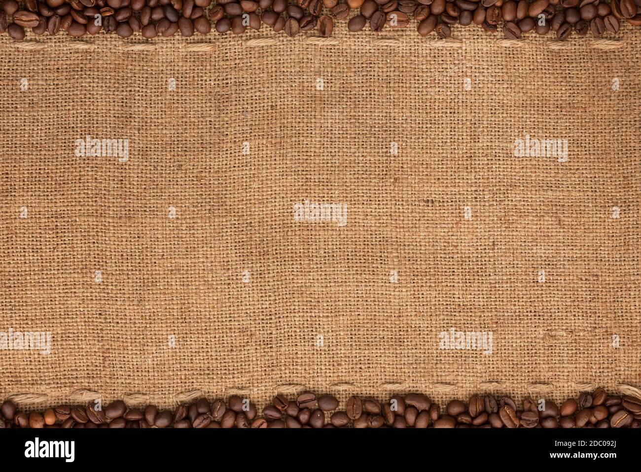 Coffee beans lying on sackcloth with space for text Stock Photo