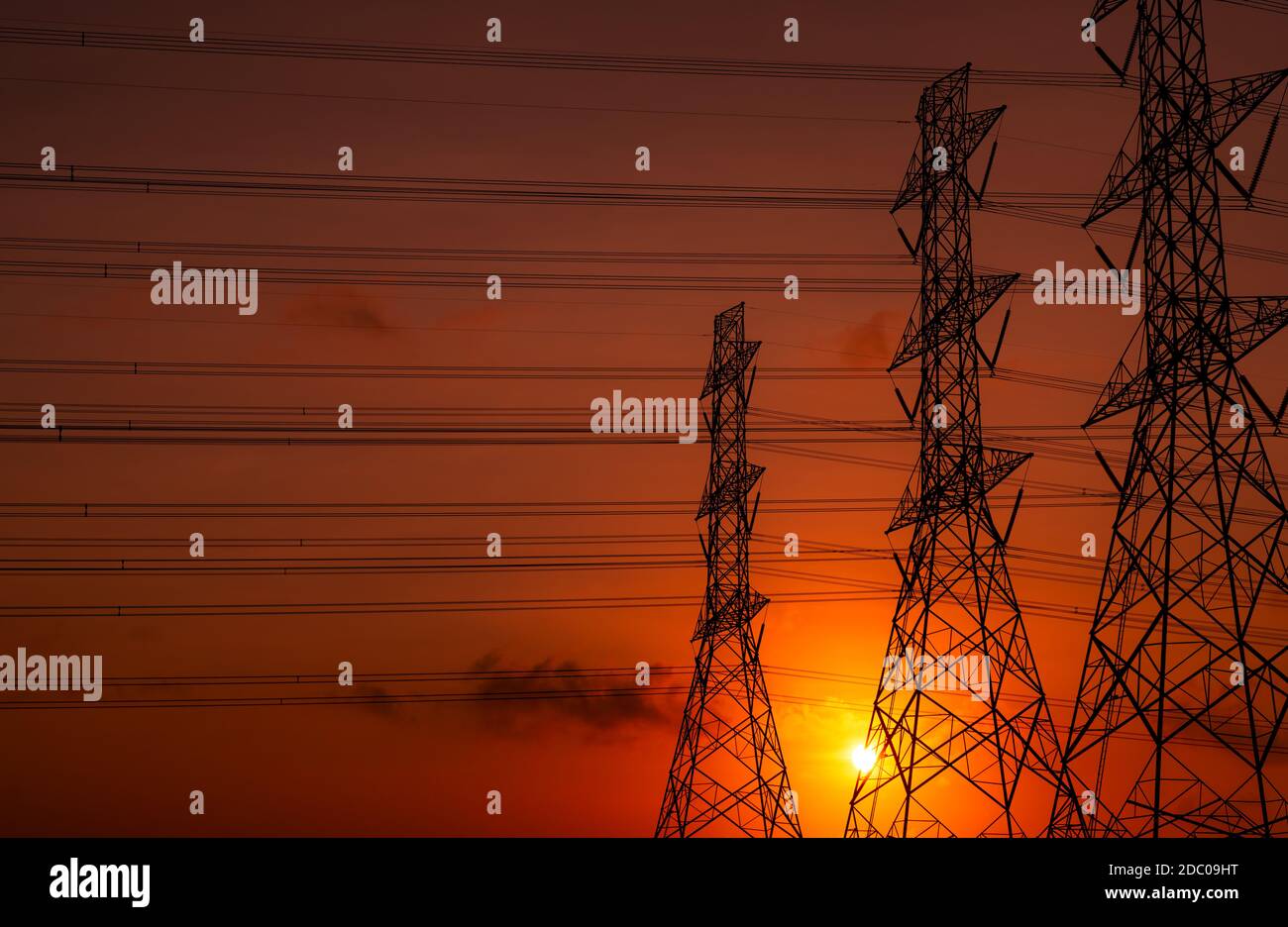 High voltage electric pole and transmission lines in the evening ...
