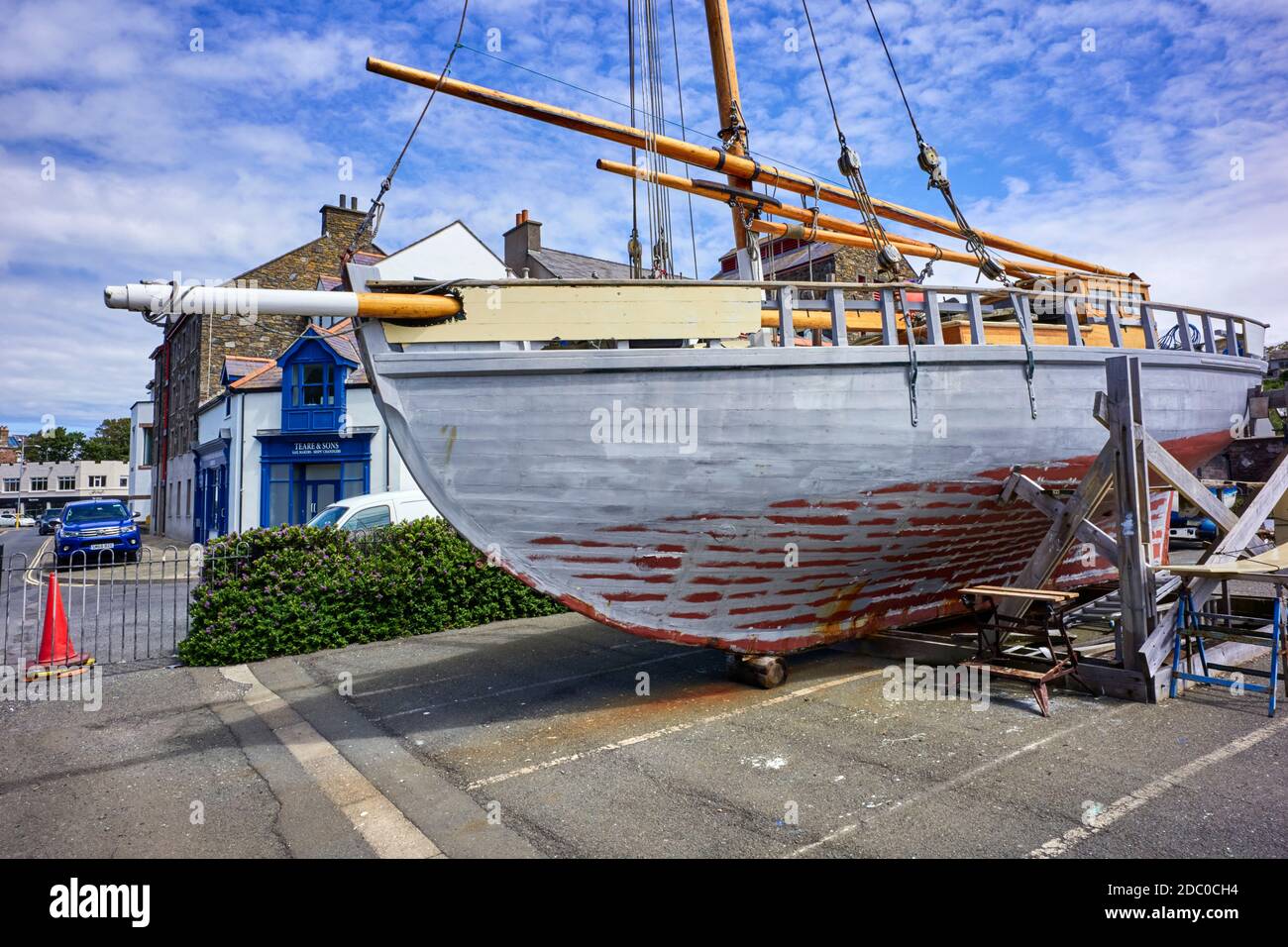 Manx Nobby fishing boat White Heather undergoing refurbishment on the quayside at Peel, Isle of Man just a short distance from where she was first con Stock Photo