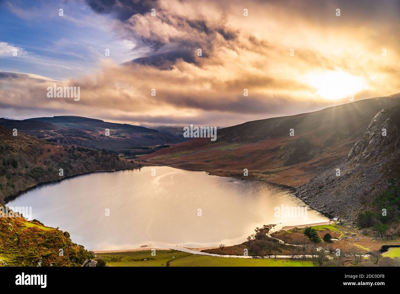 Dramatic sunset at Lake Lough Tay or The Guinness Lake in County Wicklow where Vikings village, Kattegat was located, Wicklow Mountains, Ireland Stock Photo