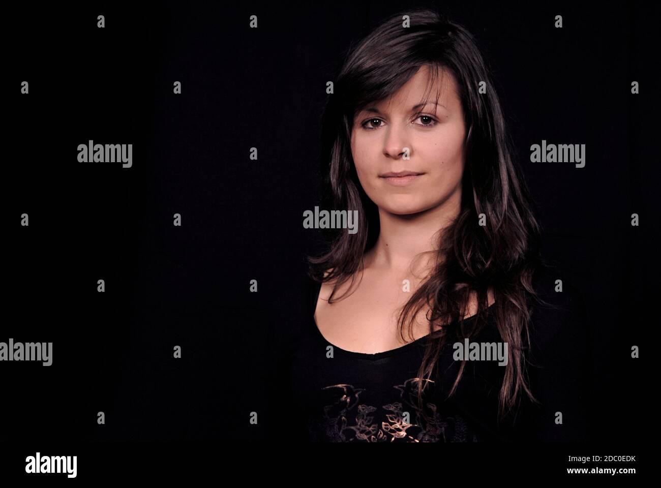 Young beautiful woman portrait on black background Stock Photo - Alamy