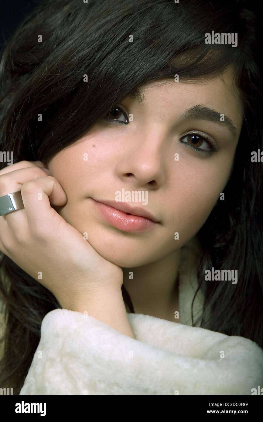 young beautiful brunette portrait against black background Stock Photo ...