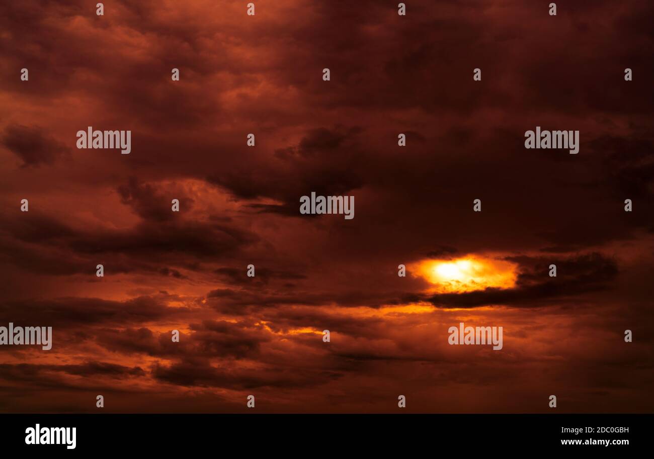 Dramatic red cloudy sky abstract background. Red and black clouds on