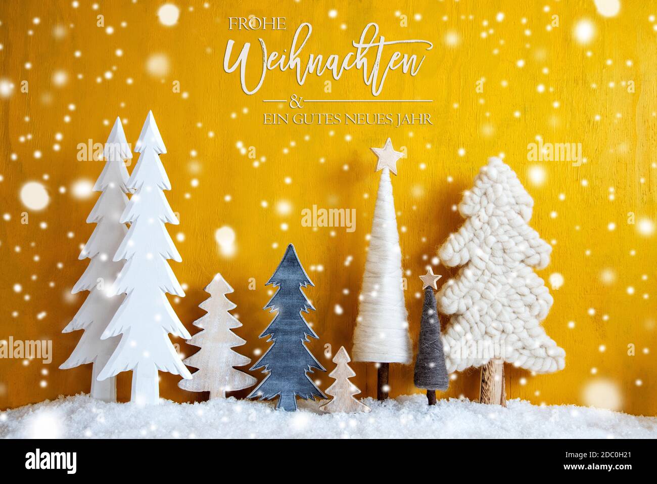 Trees With German Calligraphy Frohe Weihnachten Und Ein Gutes Neues Jahr Means Merry Christmas And A Happy New Year. Yellow Background With Snow And S Stock Photo