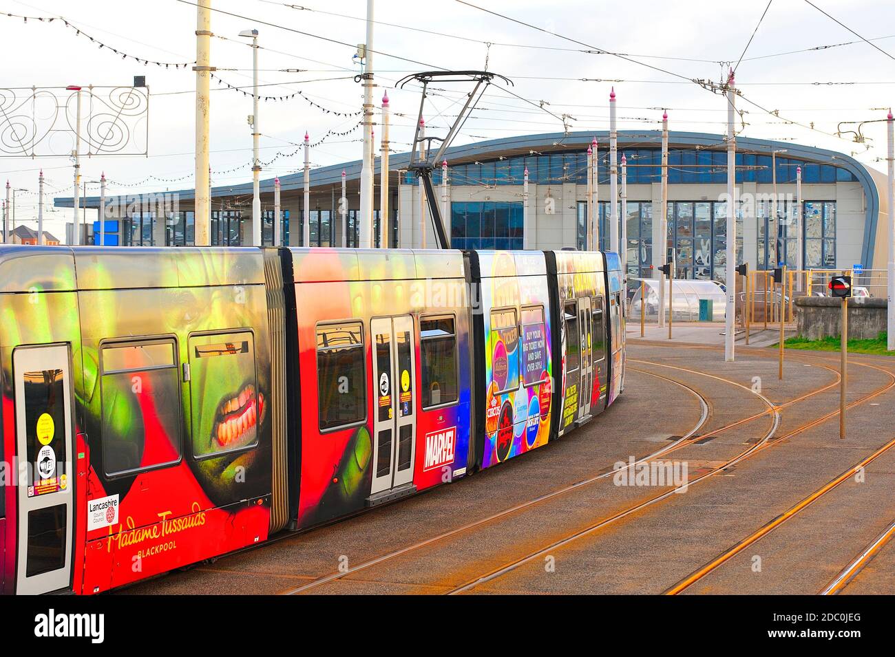 Colourful tram covered in advertising graphics arrives at the depot terminus in Blackpool Stock Photo