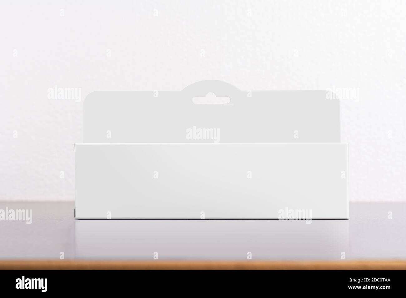 Rectangular box package mockup with hanger on table, editable mock-up series template ready for your design, faces selection path included. Stock Photo