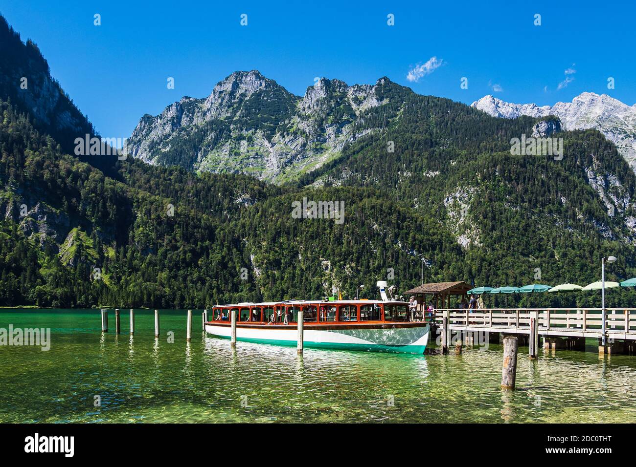 Lake Koenigssee with rocks and excursion boat in the Berchtesgaden Alps ...