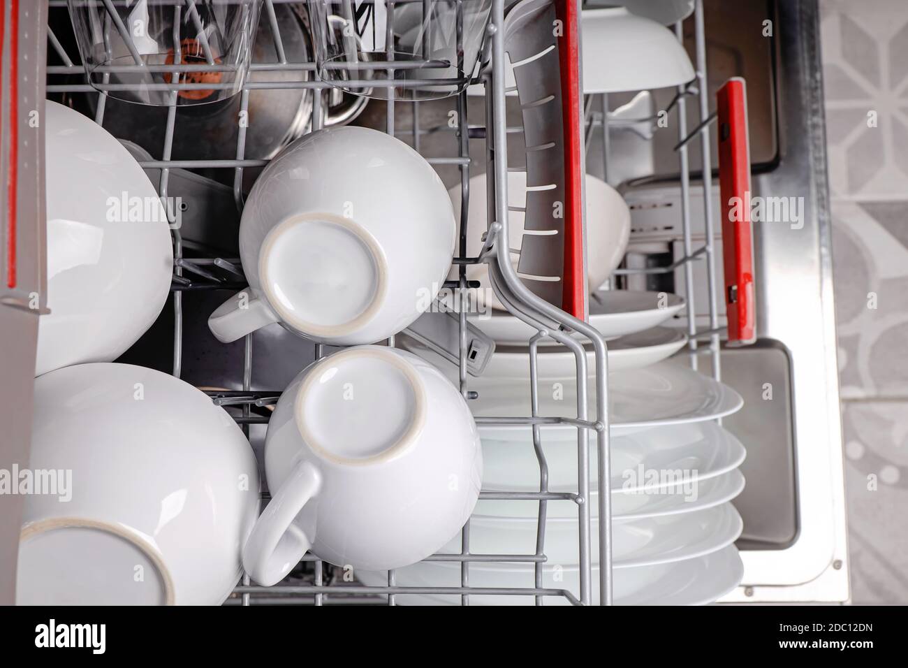 Open dishwasher full of clean cups and dishes Stock Photo Alamy